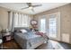 Comfortable main bedroom featuring a ceiling fan and backyard access at 5407 W Cambridge Ave, Phoenix, AZ 85035