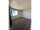 Bedroom with a large window offering natural light and neutral colored carpet at 5929 N 48Th Ave, Glendale, AZ 85301