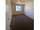 This cozy bedroom offers a ceiling fan and a window with a view at 5929 N 48Th Ave, Glendale, AZ 85301
