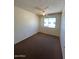 A simple bedroom includes a ceiling fan and a window at 5929 N 48Th Ave, Glendale, AZ 85301