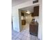 Galley kitchen features tile floors, wood cabinets, and modern appliances at 5929 N 48Th Ave, Glendale, AZ 85301