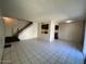 Open concept living room with tile floors and a staircase leading to the upper level at 5929 N 48Th Ave, Glendale, AZ 85301