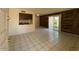 Bright living room features tile floors, wood accent wall, and sliding glass door to backyard at 5929 N 48Th Ave, Glendale, AZ 85301