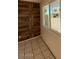 Bright room with tile floors and wood accent wall with a view of the exterior at 5929 N 48Th Ave, Glendale, AZ 85301
