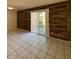 Bright living room features tile floors, wood accent wall, and sliding glass door to backyard at 5929 N 48Th Ave, Glendale, AZ 85301