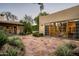 Picturesque backyard with stone pavers, lush greenery, and a glimpse of the home's architecture at 6019 N 62Nd Pl, Paradise Valley, AZ 85253