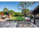 Expansive backyard features lush lawn, mature trees, and a covered patio area perfect for outdoor living at 6019 N 62Nd Pl, Paradise Valley, AZ 85253