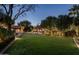 Backyard oasis with artificial turf, ambient lighting, and comfortable seating areas for entertaining at 6019 N 62Nd Pl, Paradise Valley, AZ 85253