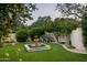 Lovely backyard with a decorative fountain, lush greenery, and well-manicured landscaping at 6019 N 62Nd Pl, Paradise Valley, AZ 85253