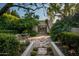 Beautiful backyard featuring a stone patio, lush landscaping, and a seating area at 6019 N 62Nd Pl, Paradise Valley, AZ 85253