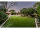 Spacious backyard with artificial turf, landscaped gardens, and a cozy seating area for relaxing at 6019 N 62Nd Pl, Paradise Valley, AZ 85253