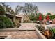 Charming backyard with brick patio, lush greenery, and a cozy seating area, perfect for outdoor enjoyment at 6019 N 62Nd Pl, Paradise Valley, AZ 85253