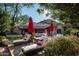 Lush backyard featuring elegant lounge chairs, mature trees, and a glimpse of the charming home exterior at 6019 N 62Nd Pl, Paradise Valley, AZ 85253