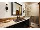 The bathroom boasts a dark vanity with marble counters and a large shower with glass door at 6019 N 62Nd Pl, Paradise Valley, AZ 85253