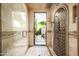 Beautifully tiled shower with an open door to a lush outdoor space, blending indoor and outdoor living at 6019 N 62Nd Pl, Paradise Valley, AZ 85253