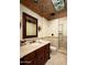 Bathroom with a detailed vanity, stone countertop, and glass-enclosed shower showcasing luxurious design at 6019 N 62Nd Pl, Paradise Valley, AZ 85253