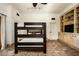 Spacious bedroom with a bunk bed and custom built-in shelving, offering ample storage and modern living at 6019 N 62Nd Pl, Paradise Valley, AZ 85253