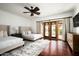 Bright bedroom with two beds, hardwood floors, and doors that open to a tranquil outdoor view at 6019 N 62Nd Pl, Paradise Valley, AZ 85253