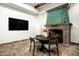 Cozy dining area with a decorative fireplace, brick floors, and comfortable seating for a relaxed atmosphere at 6019 N 62Nd Pl, Paradise Valley, AZ 85253