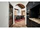 Elegant dining room with a long table, wood ceiling, and arched doorway for a sophisticated look at 6019 N 62Nd Pl, Paradise Valley, AZ 85253