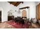Elegant dining room with a long table, wood ceiling, and arched doorway for a sophisticated look at 6019 N 62Nd Pl, Paradise Valley, AZ 85253