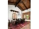 Elegant dining room featuring wood beam ceiling, brick floors, area rug, and a chandelier at 6019 N 62Nd Pl, Paradise Valley, AZ 85253