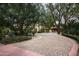 Expansive circular driveway with mature trees leading to a charming home at 6019 N 62Nd Pl, Paradise Valley, AZ 85253
