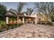 Inviting covered patio with comfortable seating and an outdoor grill, surrounded by landscaped grounds at 6019 N 62Nd Pl, Paradise Valley, AZ 85253