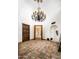 Grand foyer featuring high ceilings, terracotta floors, and a striking chandelier, creating an inviting entrance at 6019 N 62Nd Pl, Paradise Valley, AZ 85253