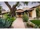 Inviting front entrance with a tile walkway and lush desert landscaping, offering curb appeal at 6019 N 62Nd Pl, Paradise Valley, AZ 85253