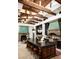 Luxurious kitchen featuring a large island, brick floors, and a decorative range hood with stainless steel appliances at 6019 N 62Nd Pl, Paradise Valley, AZ 85253
