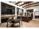 Spacious kitchen featuring an island with seating, a dining table, and dark wood cabinets for a rustic feel at 6019 N 62Nd Pl, Paradise Valley, AZ 85253