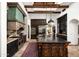 Spacious kitchen with dark wood cabinets, stainless steel appliances, and a large island for cooking and entertaining at 6019 N 62Nd Pl, Paradise Valley, AZ 85253