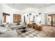 Bright living room with an arched doorway, comfortable seating, and brick floors for a warm, inviting space at 6019 N 62Nd Pl, Paradise Valley, AZ 85253