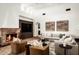 Elegant living room features a fireplace, built-in entertainment center, and comfortable seating at 6019 N 62Nd Pl, Paradise Valley, AZ 85253