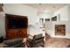 A spacious living room displays a beautiful cabinet with a tv and access to other parts of the home at 6019 N 62Nd Pl, Paradise Valley, AZ 85253