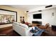 Inviting living room with hardwood floors, modern furniture, and large mirror at 6019 N 62Nd Pl, Paradise Valley, AZ 85253