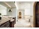 Luxurious main bathroom with dual vanities, tile flooring, and a soaking tub at 6019 N 62Nd Pl, Paradise Valley, AZ 85253