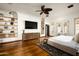 Bright main bedroom with hardwood floors, built-in shelves, and a ceiling fan at 6019 N 62Nd Pl, Paradise Valley, AZ 85253