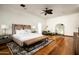 Spacious main bedroom featuring a king bed, hardwood floors, and elegant decor at 6019 N 62Nd Pl, Paradise Valley, AZ 85253