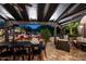 This expansive patio features comfortable seating, a large table, and an outdoor ceiling fan at 6019 N 62Nd Pl, Paradise Valley, AZ 85253