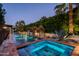 An inviting pool and spa is surrounded by lush plants and landscaping at 6019 N 62Nd Pl, Paradise Valley, AZ 85253