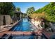 Beautiful pool with water features, surrounded by lush landscaping, offering a serene outdoor retreat at 6019 N 62Nd Pl, Paradise Valley, AZ 85253