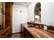 Stylish wet bar area featuring marble countertops, wood cabinets, and a decorative window for natural light at 6019 N 62Nd Pl, Paradise Valley, AZ 85253