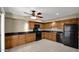 Well-lit kitchen features warm wood cabinetry and black appliances at 6448 E Paso Nuevo Dr # 101, Cave Creek, AZ 85331