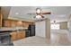 Open kitchen area with wood cabinets and modern black appliances flows into a large adjacent room at 6448 E Paso Nuevo Dr # 101, Cave Creek, AZ 85331