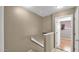 View of the stairwell with neutral paint and a half wall, showcasing the entrance to a room at 6448 E Paso Nuevo Dr # 101, Cave Creek, AZ 85331