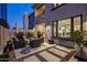 Charming backyard patio featuring a cozy fire pit, comfortable seating, and scenic views, perfect for outdoor living at 6500 E Camelback Rd # 1010, Scottsdale, AZ 85251