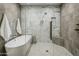 Modern bathroom featuring a freestanding tub and a glass-enclosed shower with elegant tiling at 6500 E Camelback Rd # 1010, Scottsdale, AZ 85251