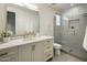 Modern bathroom with a sleek vanity, marble countertop, and a glass-enclosed shower for a spa-like experience at 6500 E Camelback Rd # 1010, Scottsdale, AZ 85251